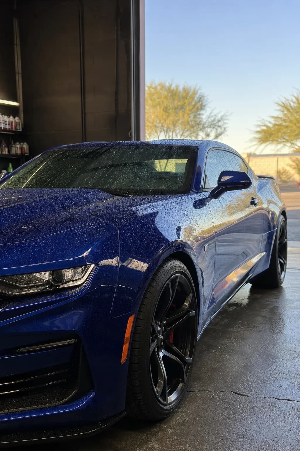 Deep blue sports coupe with tight water beading after ceramic coating